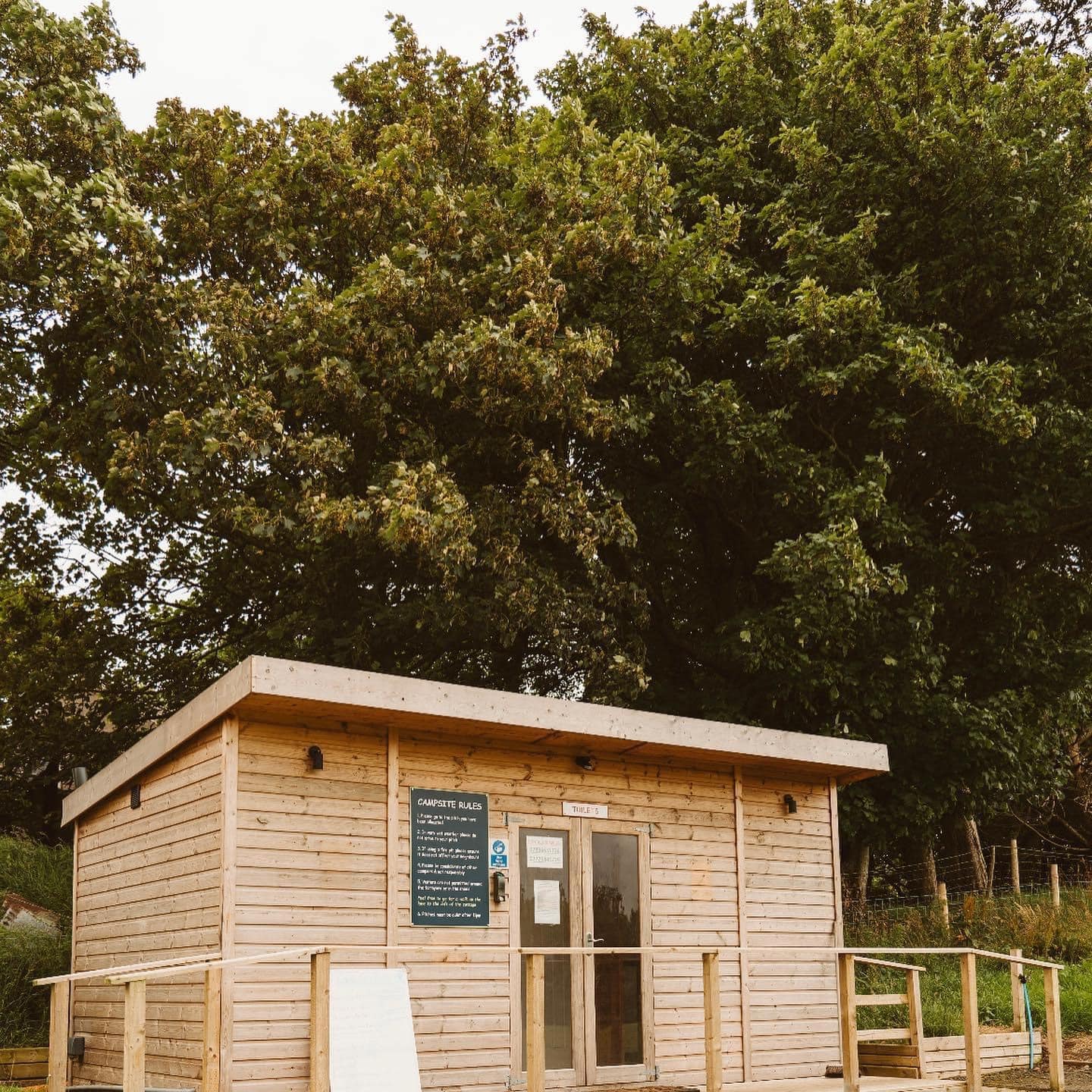 Modern timber washroom facilities and playpark installed by Ballycastle Climbing Frames at a glamping site in Ballycastle.