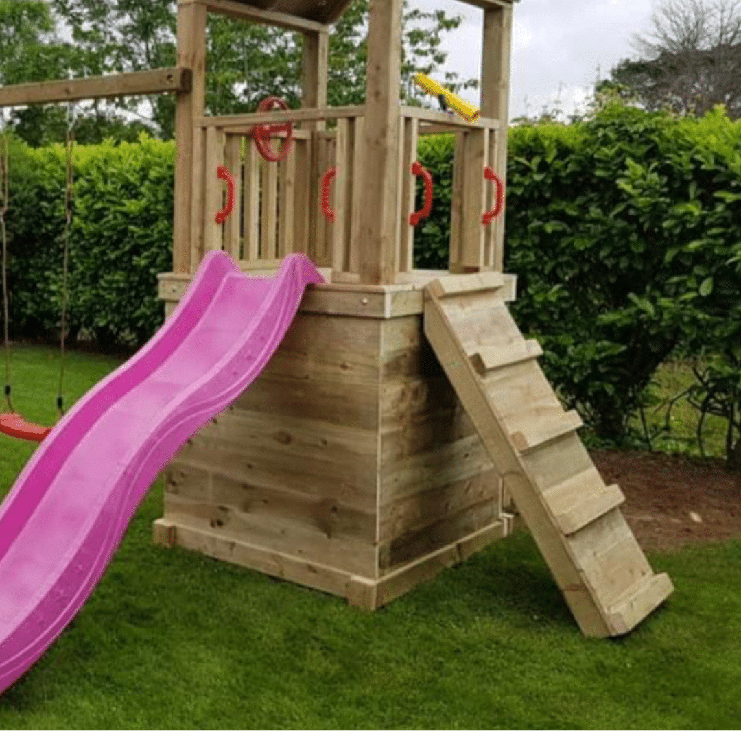 Wooden playset with pink slide, ladder, and swings in a garden.