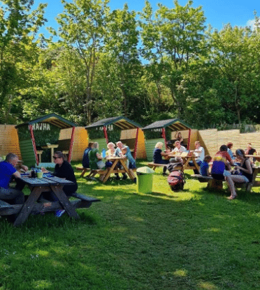 Timber outdoor dining pods installed by Ballycastle Climbing Frames for a hospitality venue in Ballintoy.